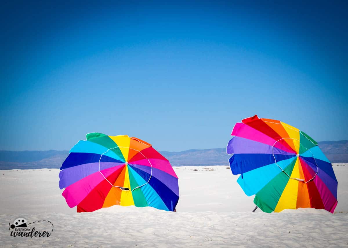 Colorful umbrellas against the white sands.