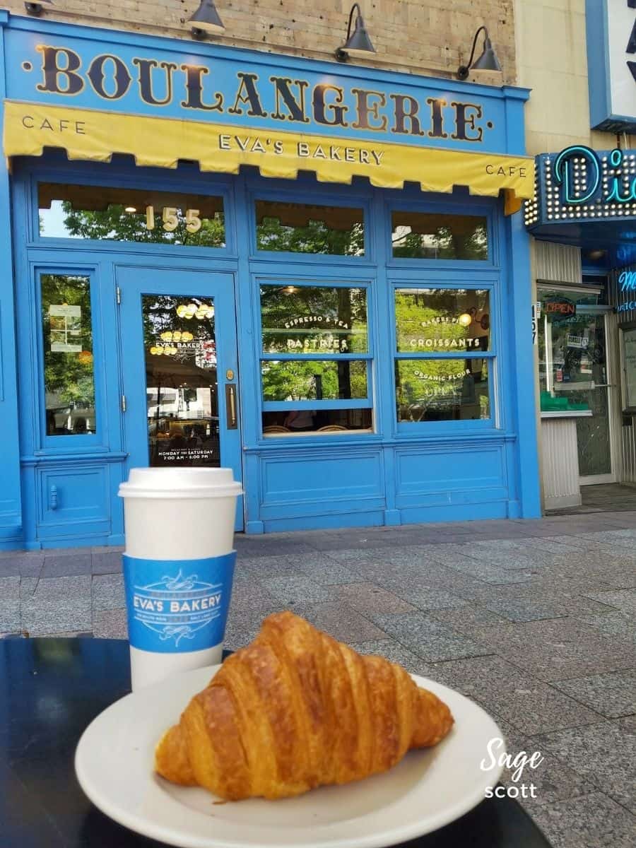 A croissant and cup of coffee outside of Eva's in Salt Lake City