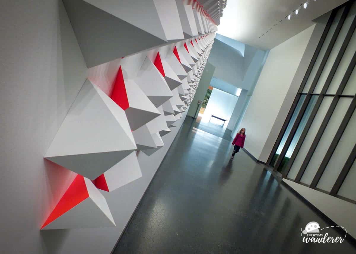 Louise walking along the fluorescent wall at the Nelson-Atkins Museum in Kansas City