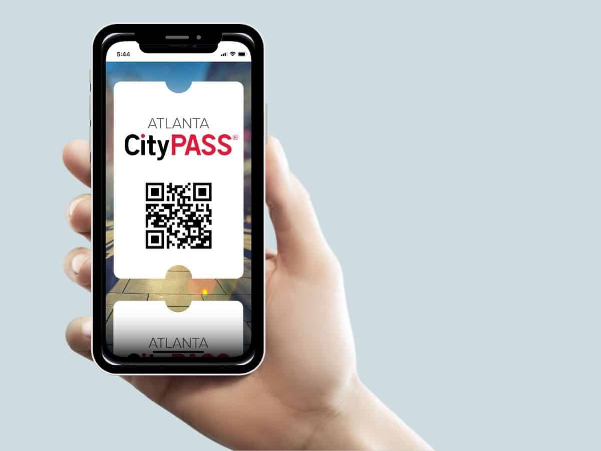 A person holding a phone with an Atlanta CityPASS mobile ticket displayed.