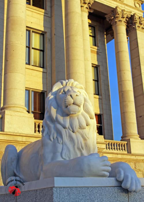 A marble lion guards the entrance to the Utah State Capitol