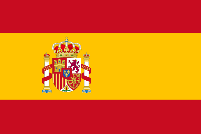 The Spanish flag features the same bright colors as the Zia sun symbol on the New Mexico flag