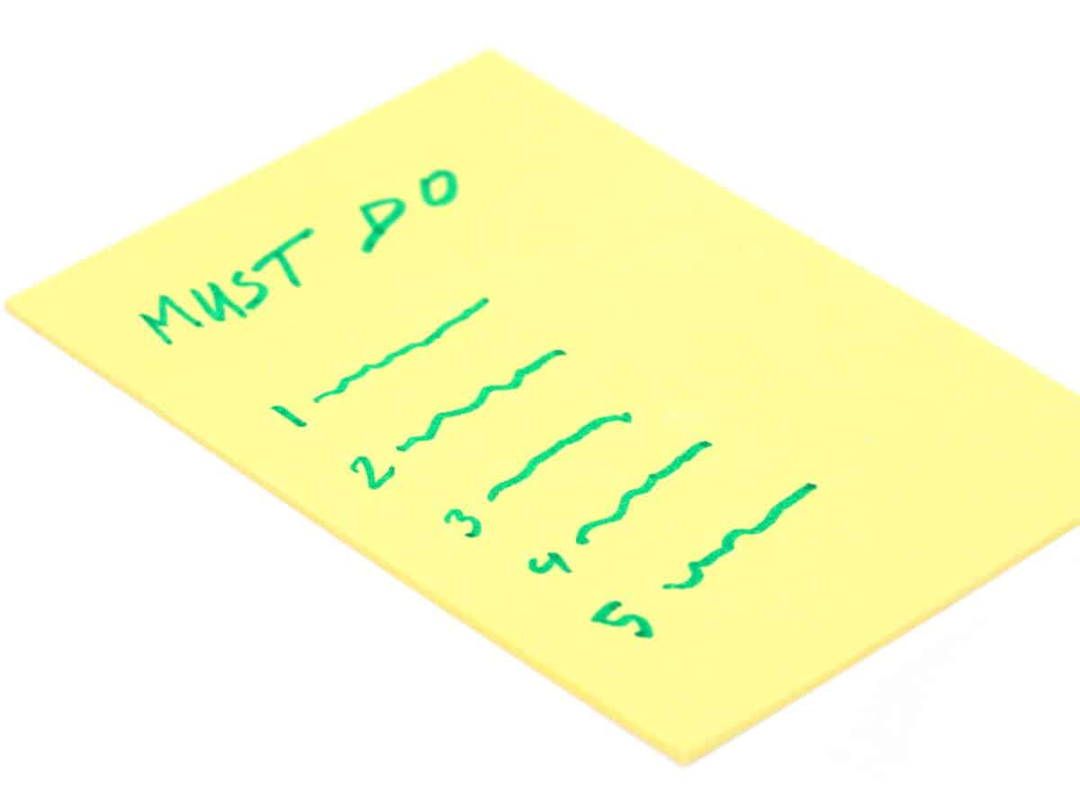 A "must do" list written on a yellow legal pad