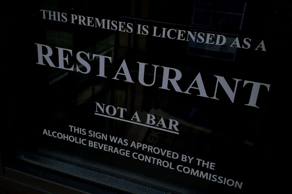Black sign indicating liquor licensing in Salt Lake City