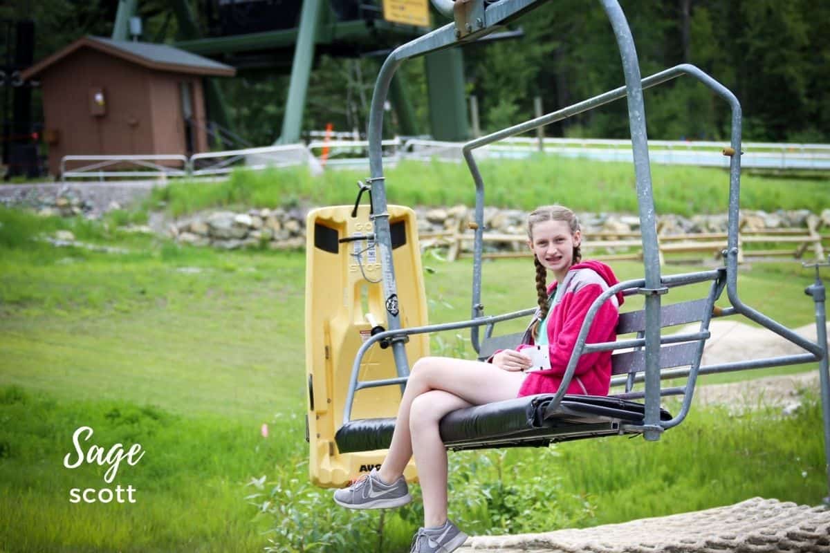 Girl riding the chairlift up Whitefish Mountain
