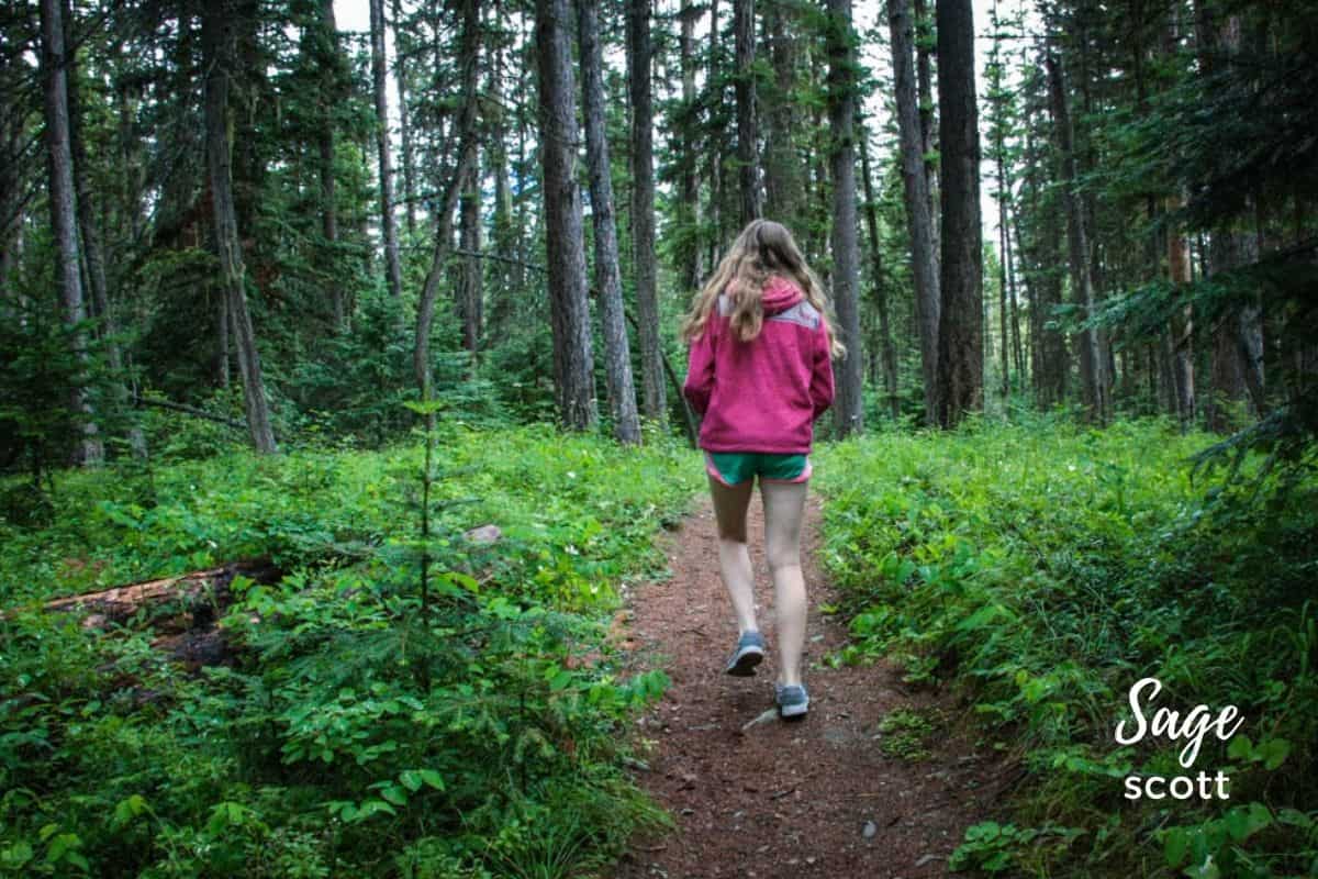A girl hiking on a mountain trail in Whitefish