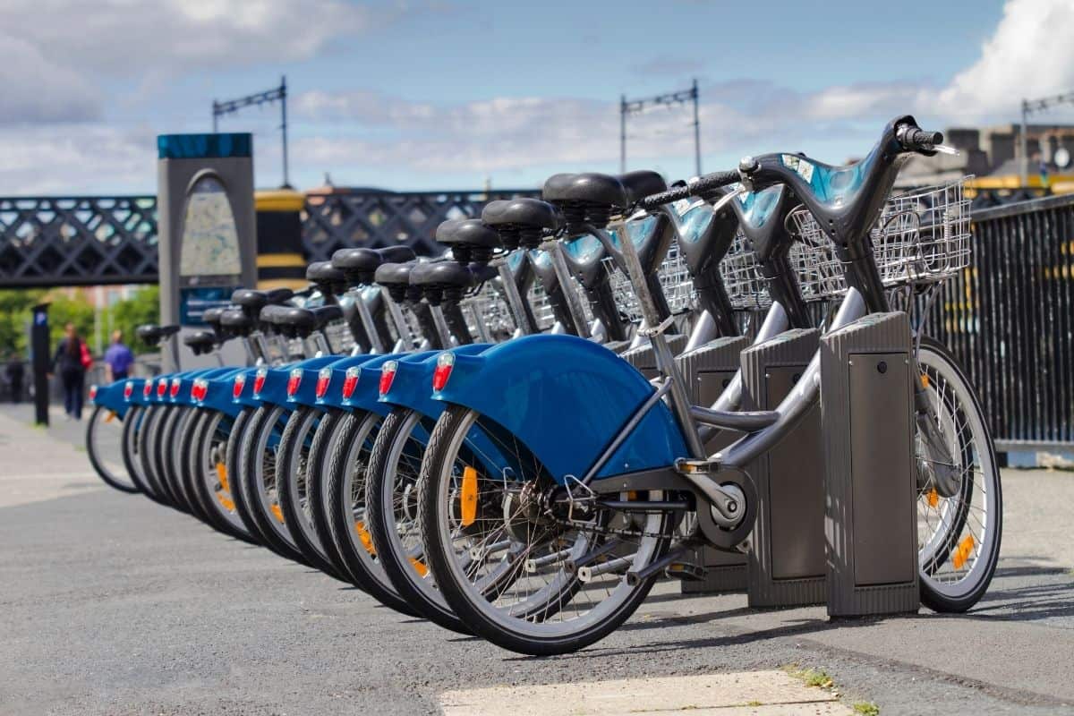 A line of blue and silver bicycles for rent