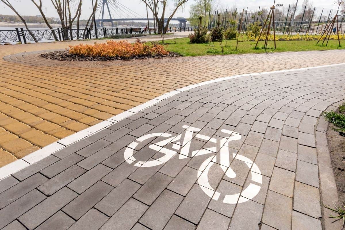 A grey brick bike path along the waterfront