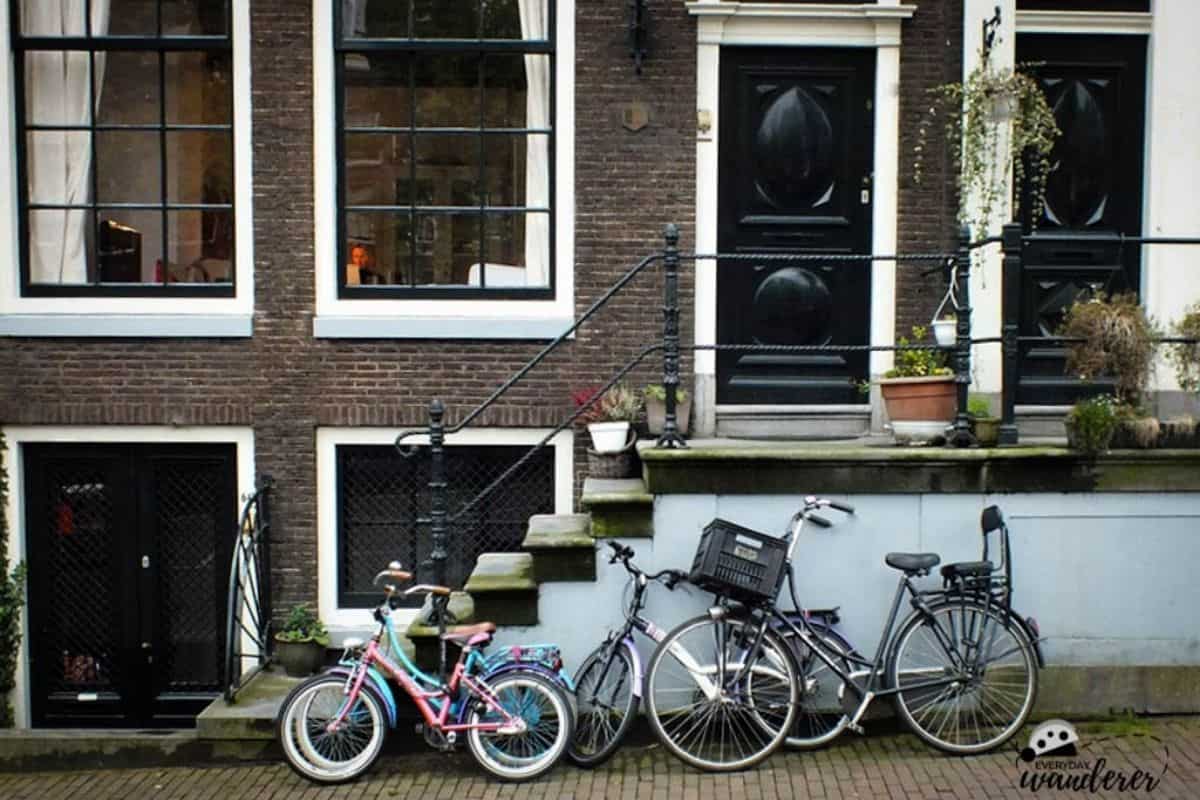 A Dutch minivan -- several bikes parked outside a home in Amsterdam
