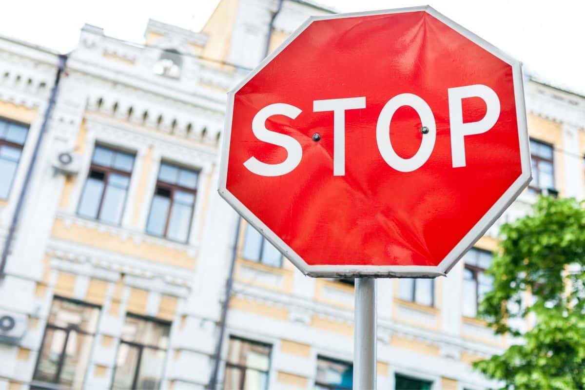 Red stop sign against a European building