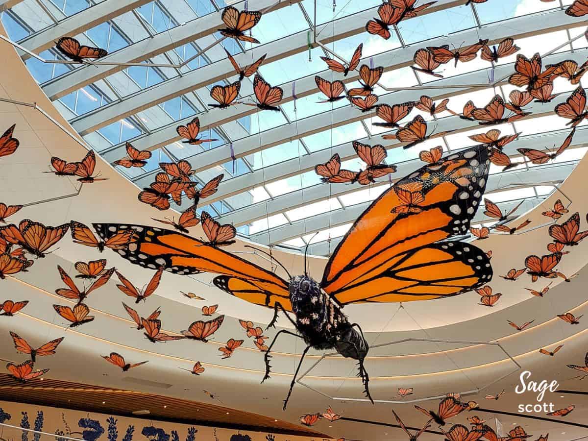 Hundreds of monarch butterflies made from repurposed materials hanging over the food court at Mall of America