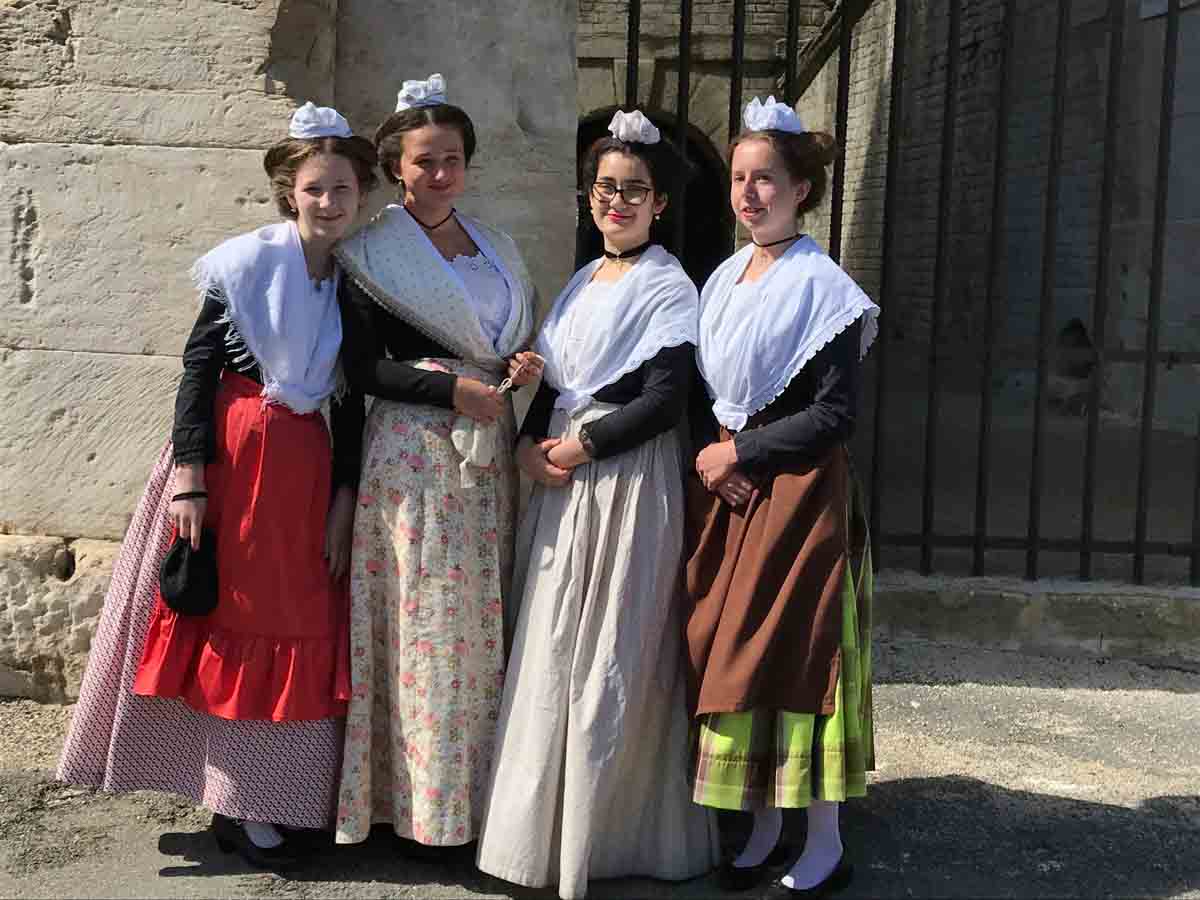 Locals dressed in period costumes for the Festival of the Herdsmen in Arles France.