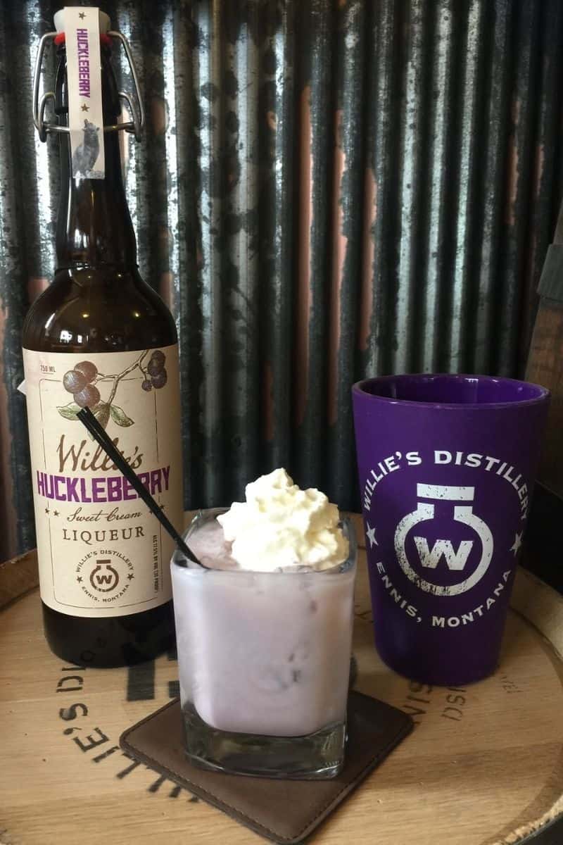 Bottle of huckleberry cream liqueur mixed into a cocktail