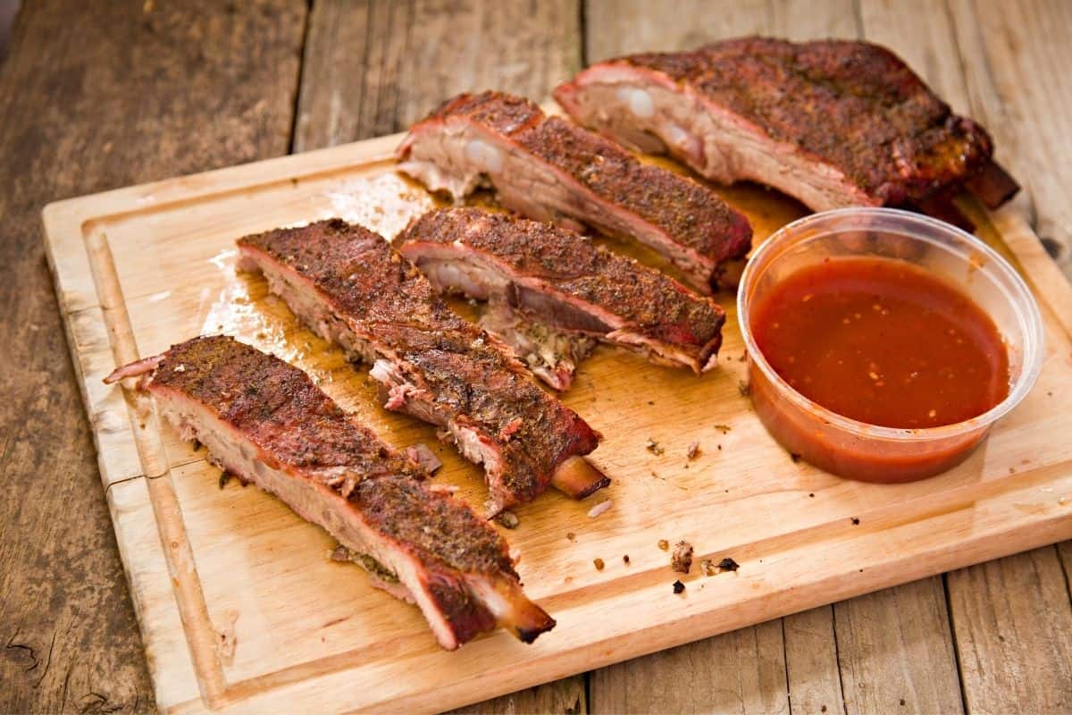 Cutting board with a slab of barbecue ribs