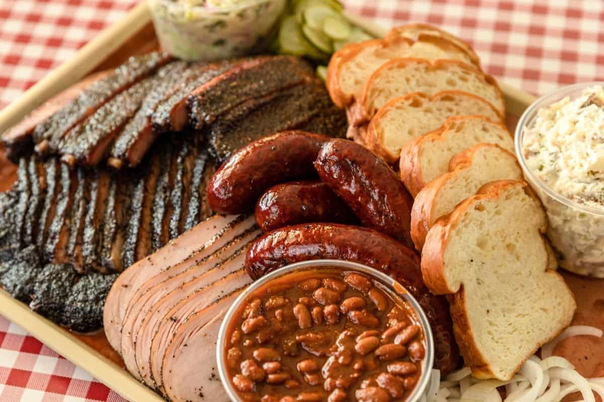 Platter of Texas barbecue on a red checkered table cloth