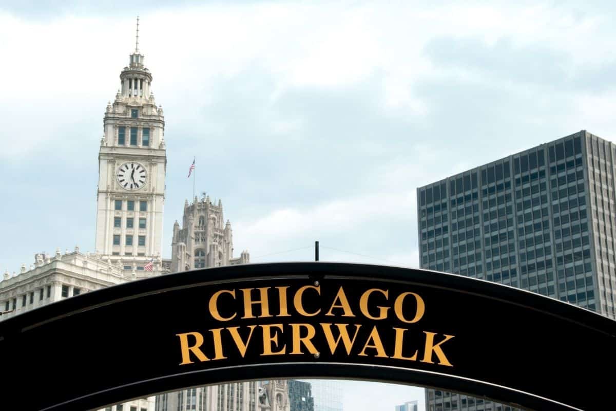 Chicago Riverwalk sign with Wrigley Building in the background