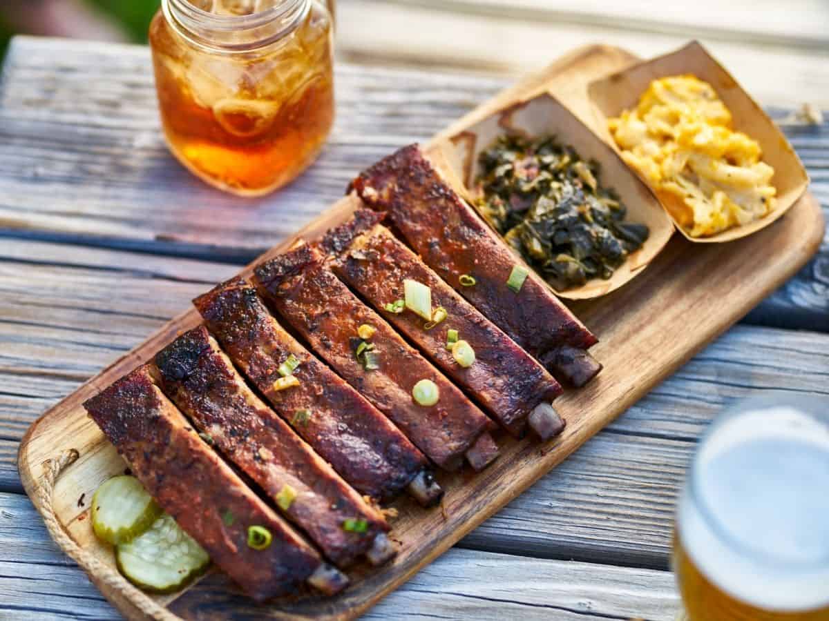 A platter of St. Louis ribs with collard greens and mac & cheese