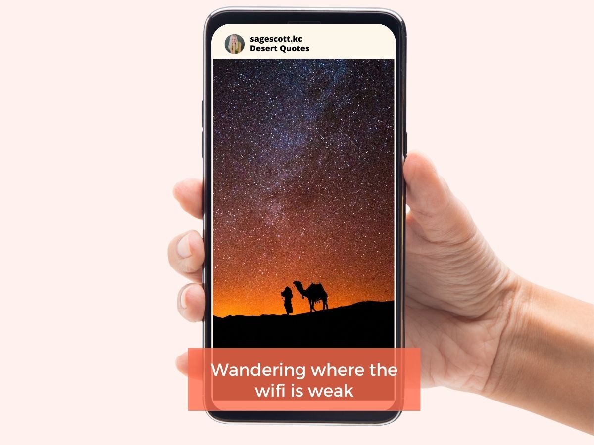 A hand holding a smartphone displaying a starry night sky with the silhouette of a camel caravan and an inspirational quote about the desert.