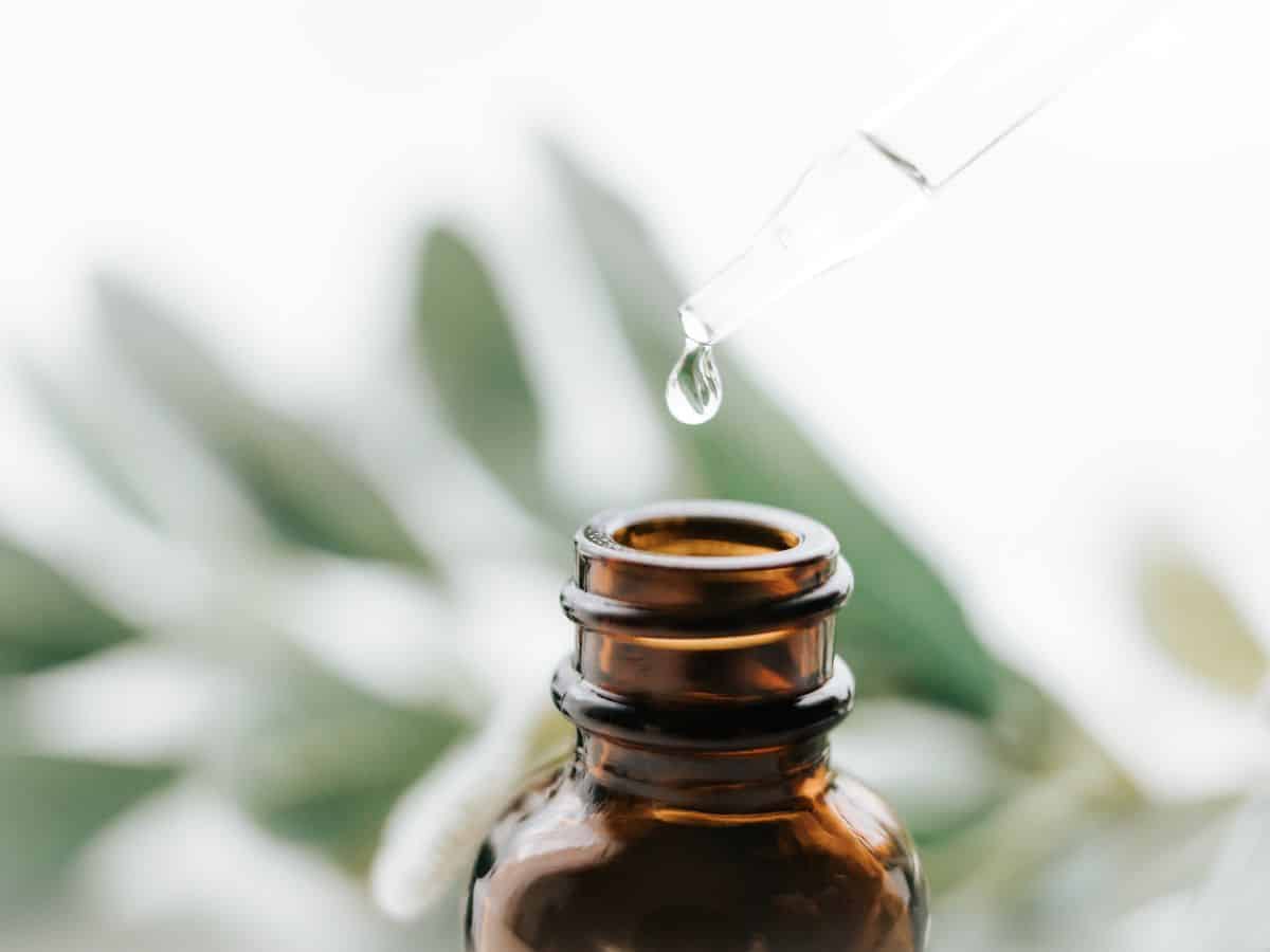 Dropper Adding Essential Oil to Bottle