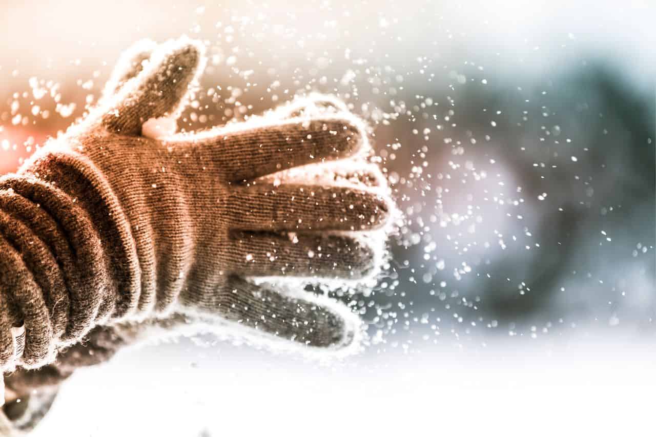 Gloved hands in the snow