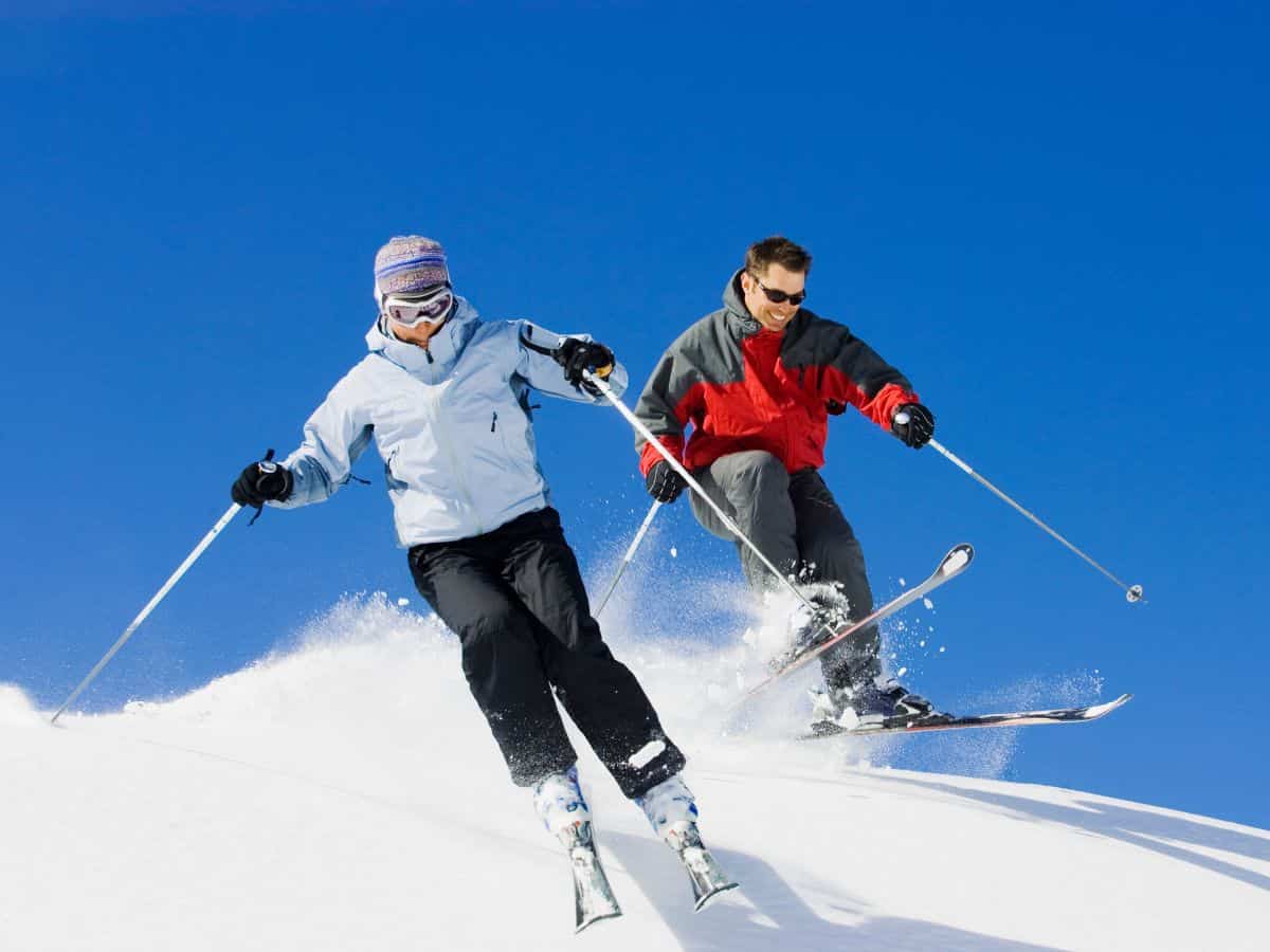 Couple Downhill Skiing