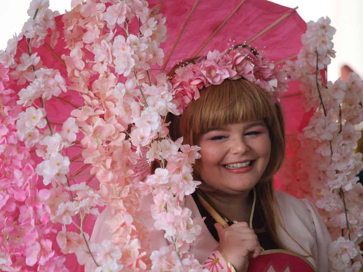 Woman under cherry blossom parasol during Nashville Cherry Blossom Festival