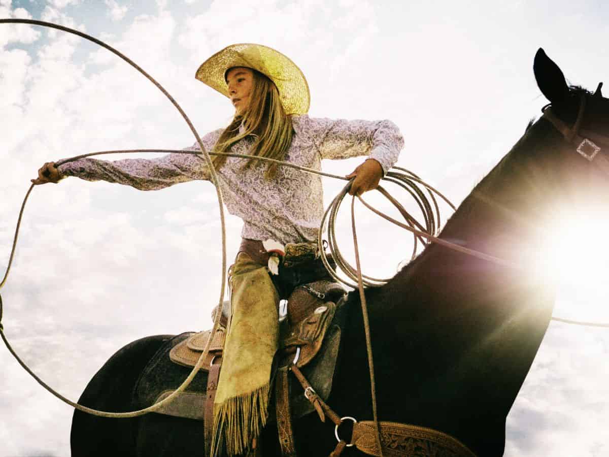 Cowgirl with a Rope Riding a Horse