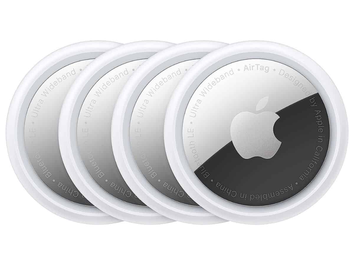 Four Apple AirTags on a white background