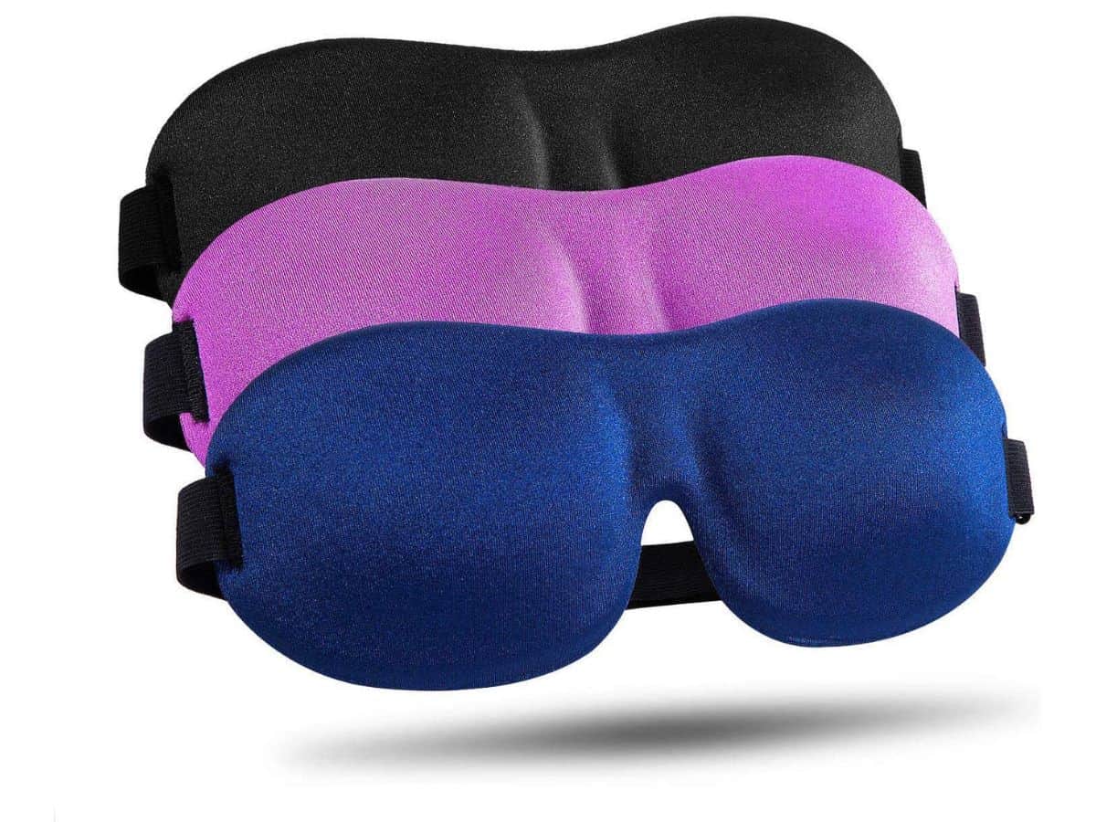 A trio of sleep masks in black, purple, and blue.