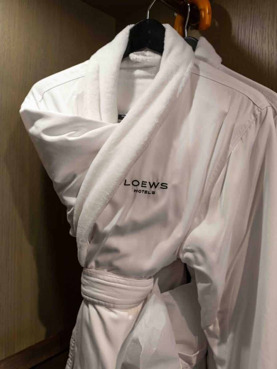 A white bathrobe hangs in the closet of Loews Kansas City Hotel.