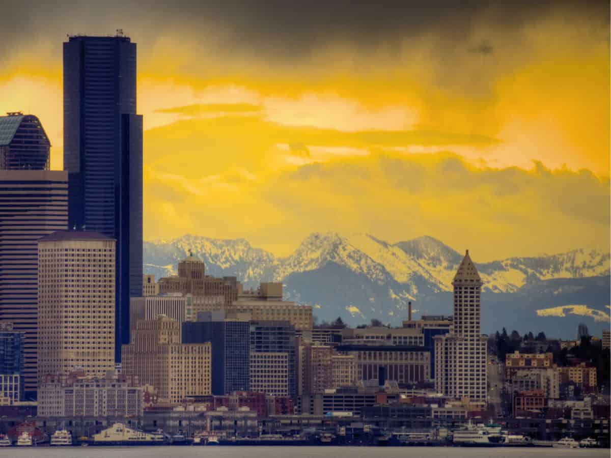 Seattle skyline with the Smith Tower and Cascade Mountains at sunset.