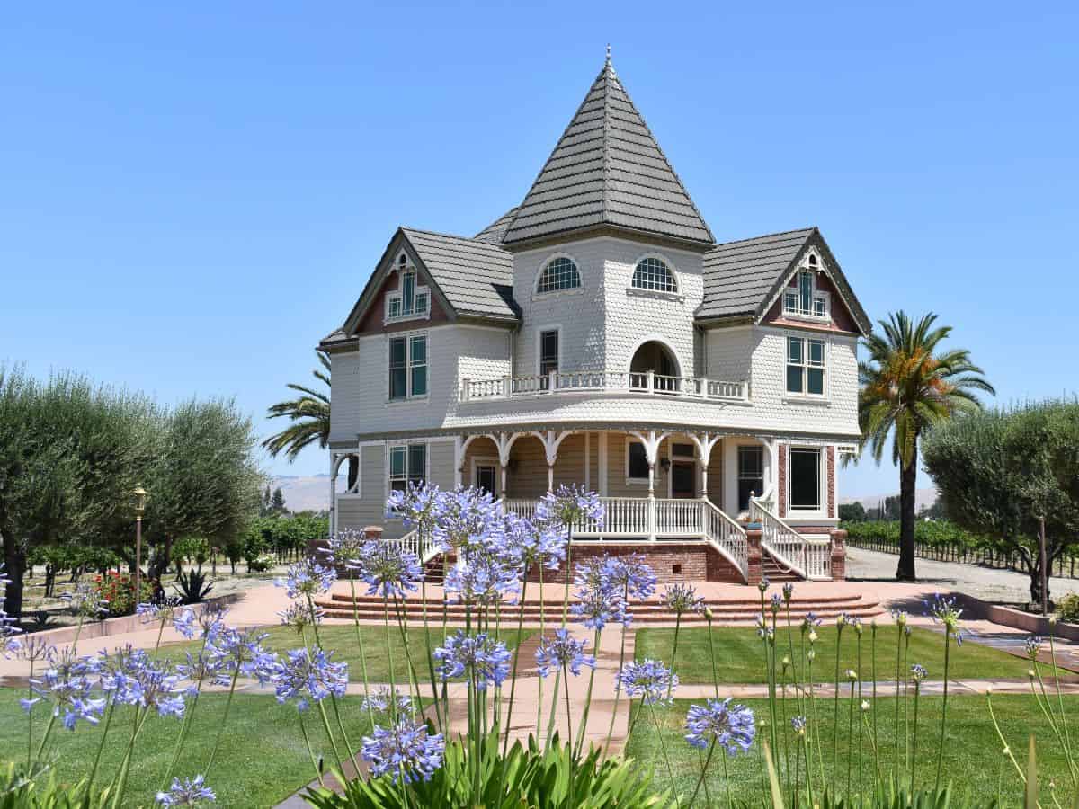 A large Victorian house with flowers in front of it at the Concannon Winery in Livermore, CA.