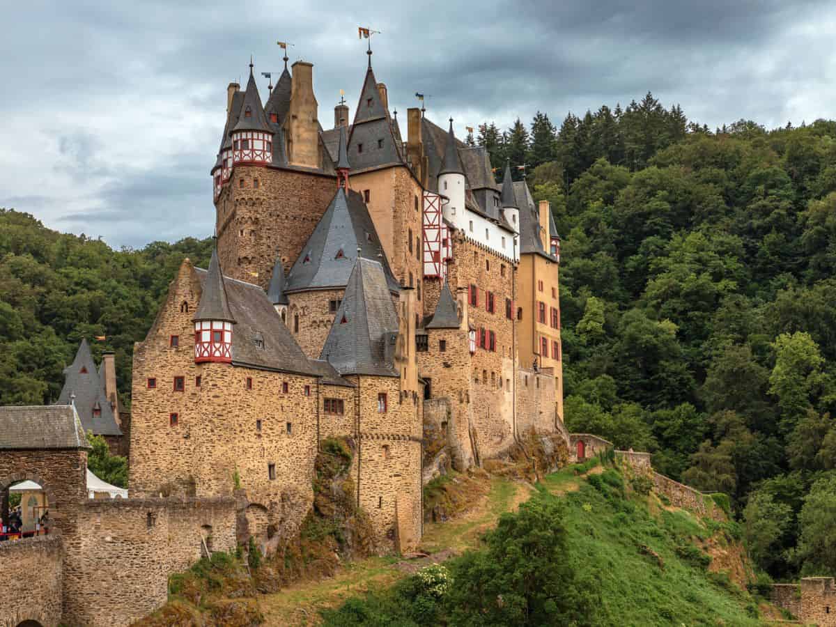 A German castle proudly stands on top of a hill hidden amongst the enchanting forest.