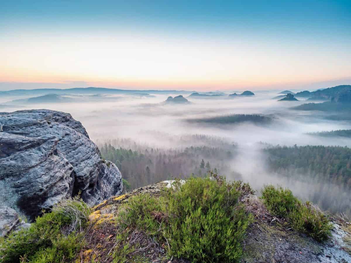 Sandstone mountains on a foggy day in Saxon Switzerland, which is actually in Germany.