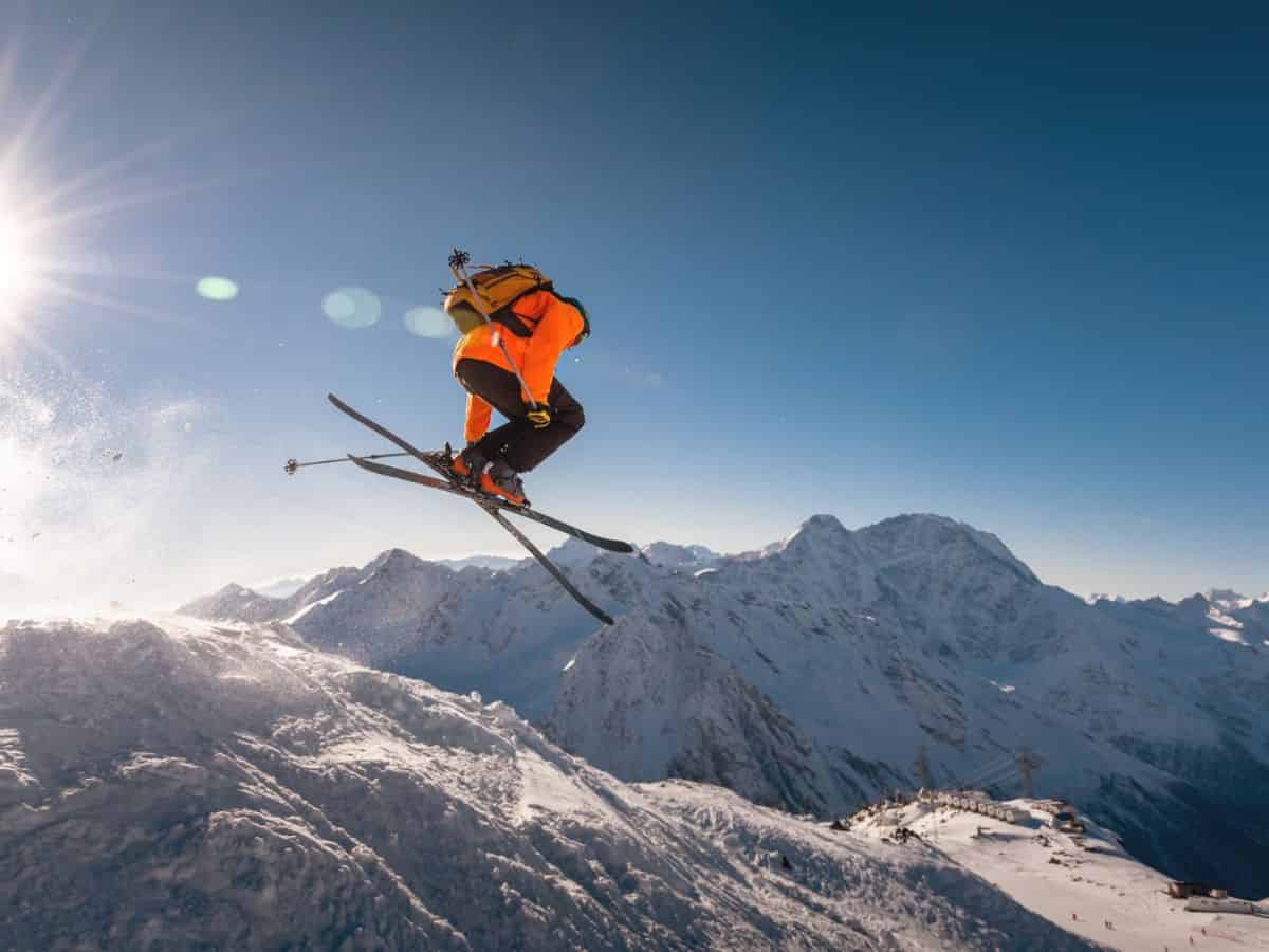 A skier soaring through the snowy mountains.