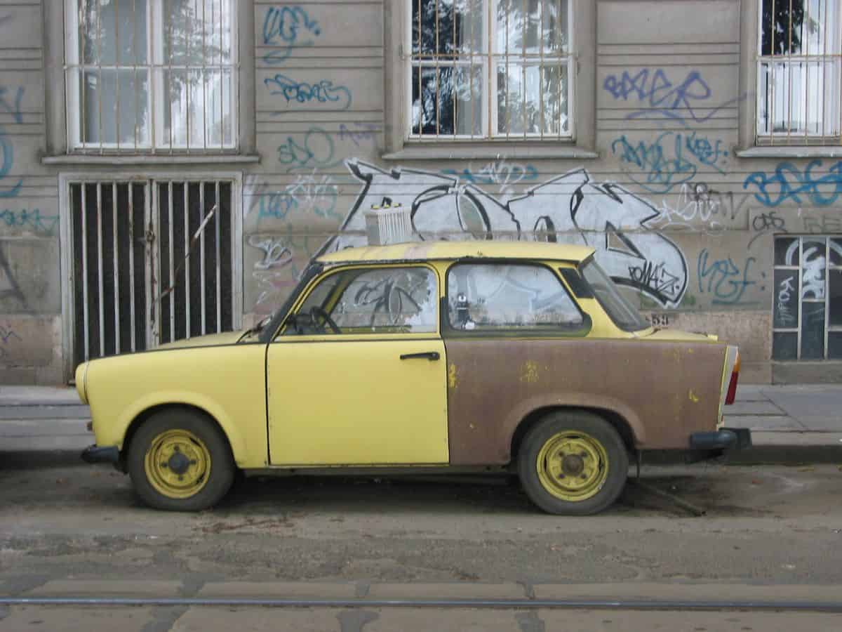 A trabant car parked in front of a building in Budapest, Hungary.