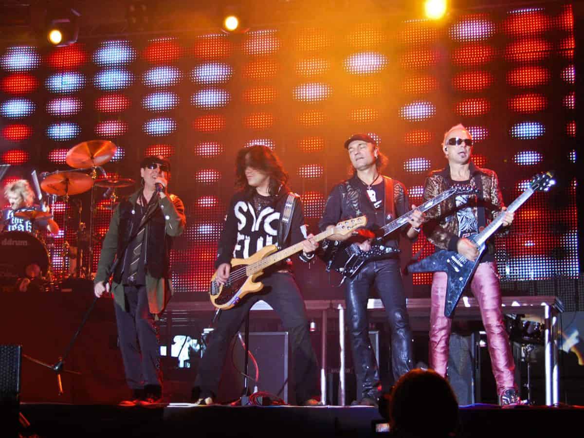 Scorpions performing on stage with guitars.