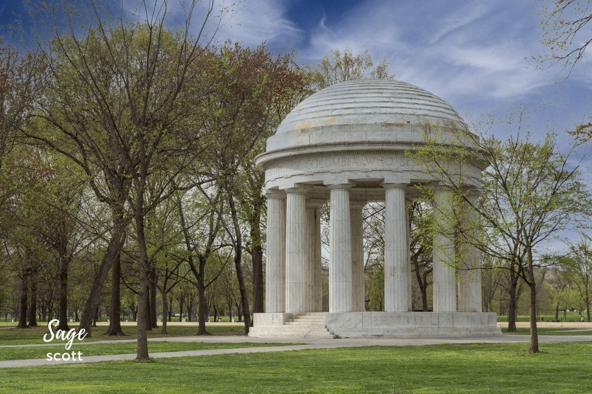 A white gazebo sits in the middle of a park within the National Mall, a renowned location in Washington DC.