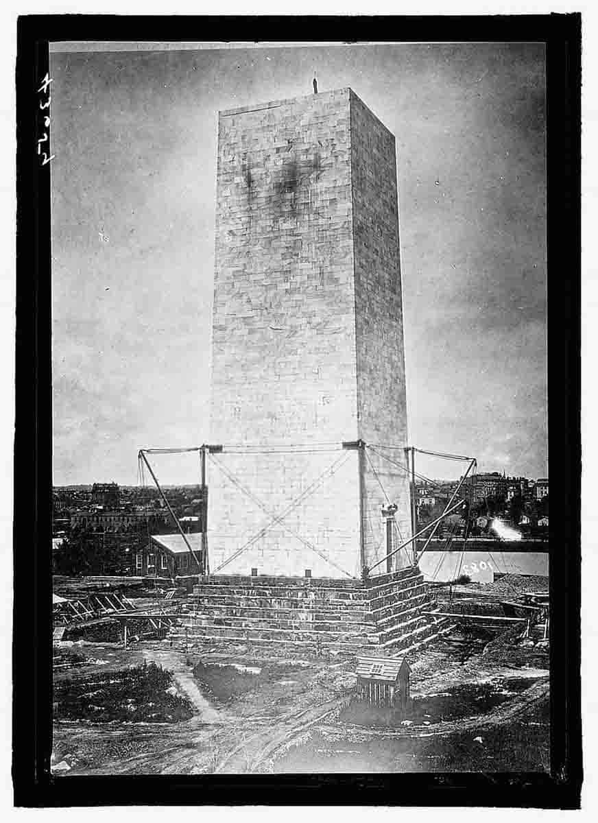 A vintage photograph capturing the construction of the Washington Monument.