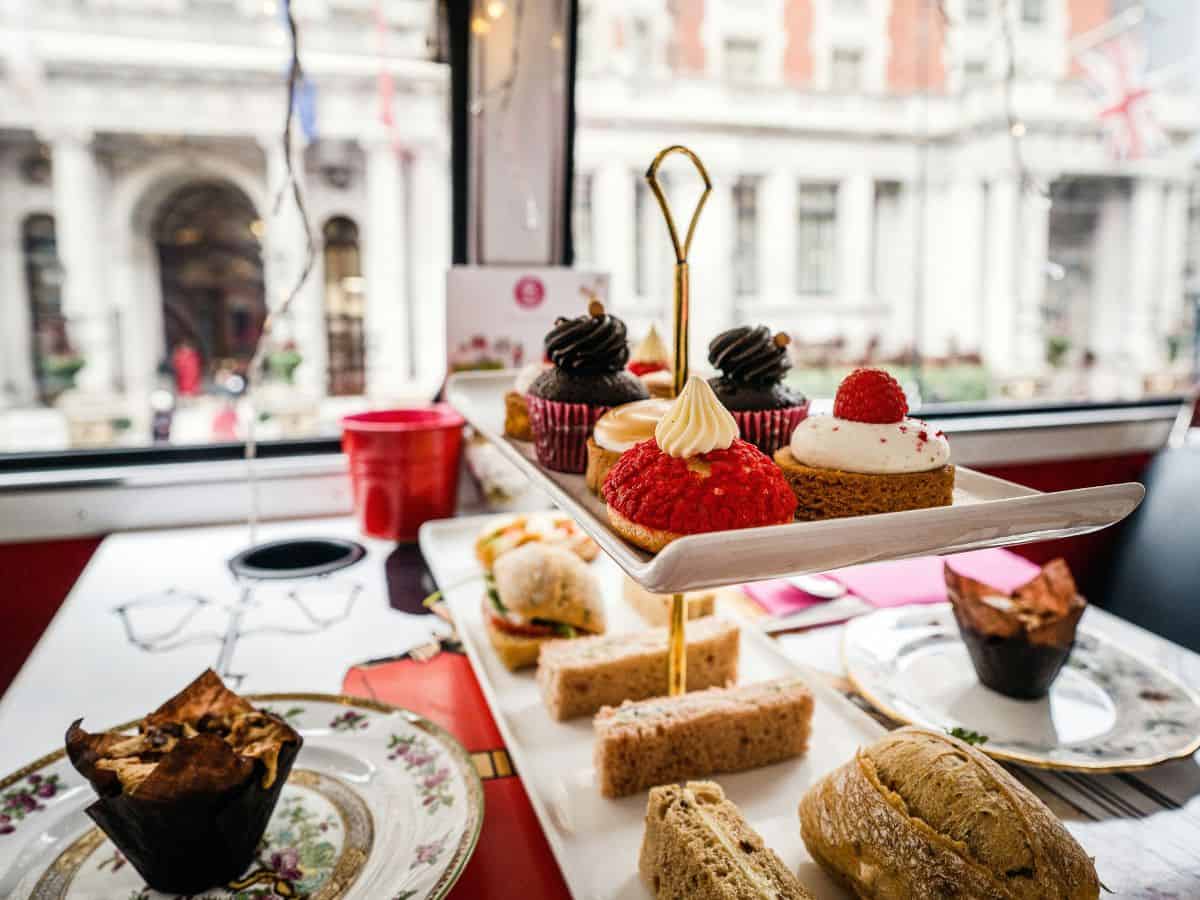 A tray of sandwiches and pastries on a table during afternoon tea.
