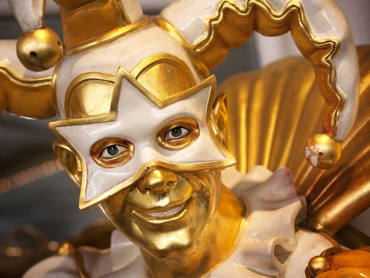 A man dressed in a golden jester costume.