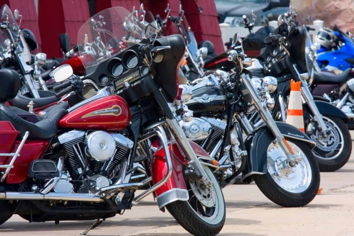 A group of motorcycles parked in a parking lot.