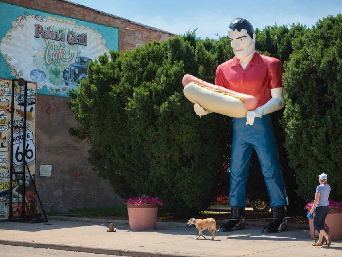 A statue of a larger than life Paul Bunyan with a hot dog along Route 66 in Illinois.