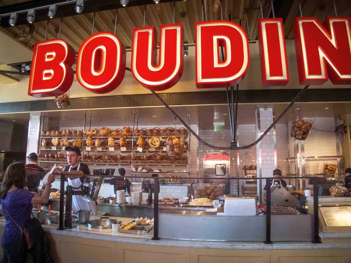 A man serving a customer at the Boudin Bakery in San Francisco.
