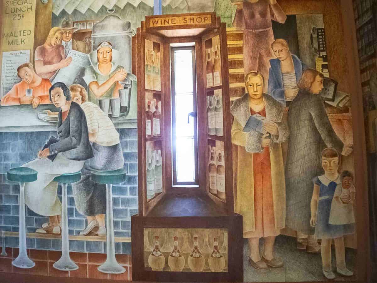 A mural depicting a group of people in a wine shop.