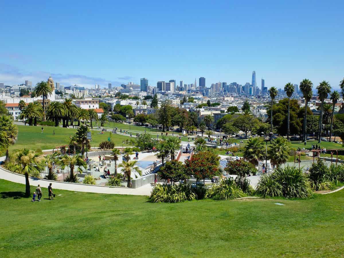 A park with mission dolores park in the background.
