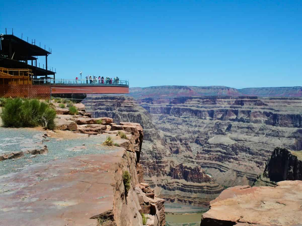 A view of the Grand Canyon Skywalk with people looking into the canyon.
