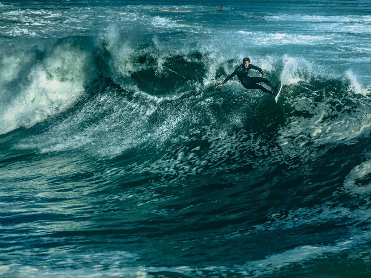 Surfer riding a large wave.