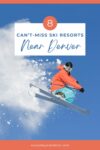 Snowboarder in an orange jacket and blue pants performing a jump against a clear blue sky. Text above reads: "8 Can't-Miss Ski Resorts Near Denver." .