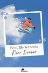 Person in orange and blue ski gear performing a jump with skis against a clear blue sky, framed by snowflakes and text that reads "Best Ski Resorts Near Denver.
